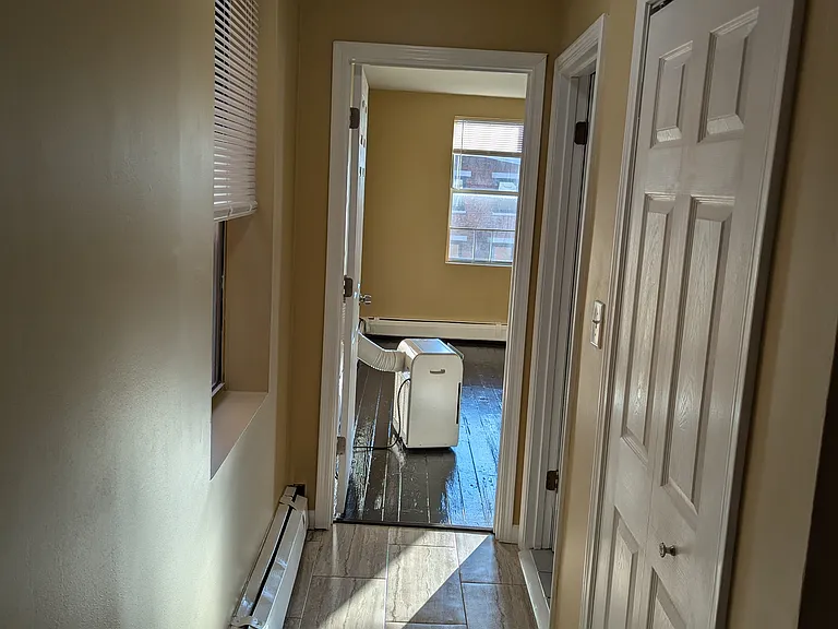 Back hallway to bathroom (right) & second bedroom, plus hallway closet