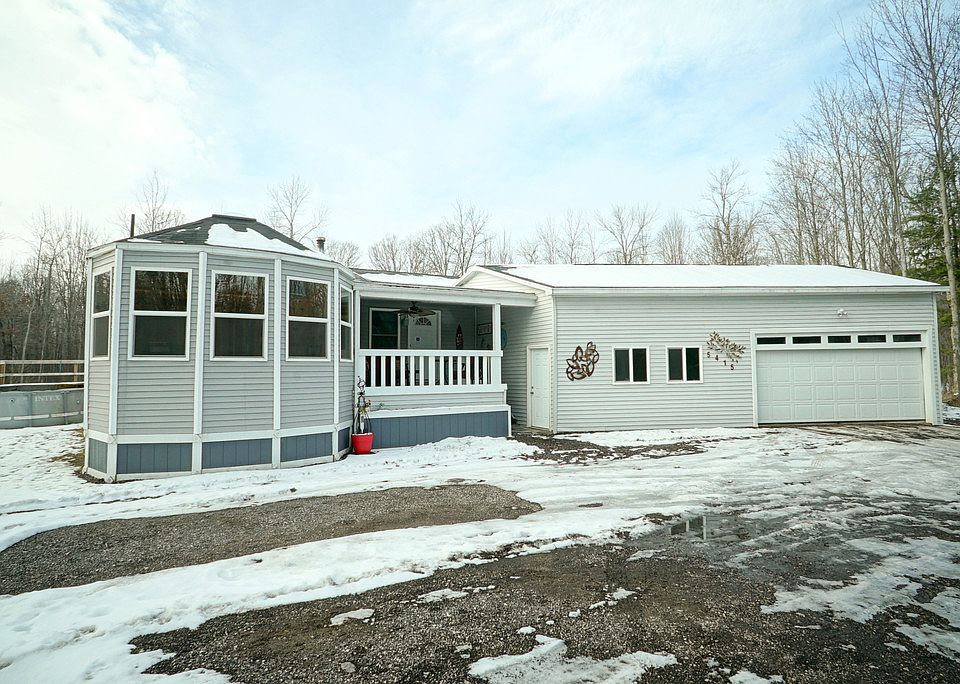 Take a deep breath of country air and enjoy this 2000 sq. ft. ranch on 5 acres near Sanford Lake.With 4 bedrooms, 2 full baths and an exciting open floor plan this will be the new "go to" home for indoor and outdoor recreation and peaceful living. The property offers, trails, private pond, above ground pool and hot tub. The 2x6 construction was crafted for energy efficiency.  City water is just another of the great features of this home. The oversized garage includes a workshop area. The extra large drive way provides ample parking for 5 vehicles. The listing includes parcel 101-023-100-414-00.