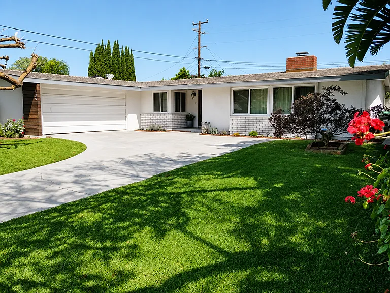 Front with two car garage and large driveway parking