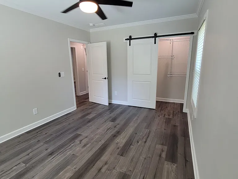 Back bedroom -- closet barndoor and shelving system in place to maximize floor space.