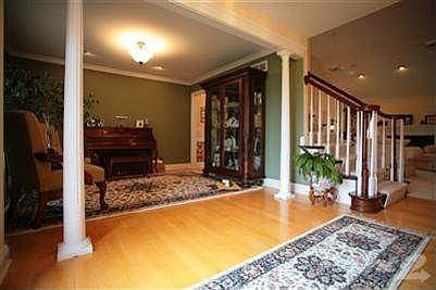 Entry foyer with view of the Dining Room (set up as a music/sitting room)and open stairs to Second Floor.