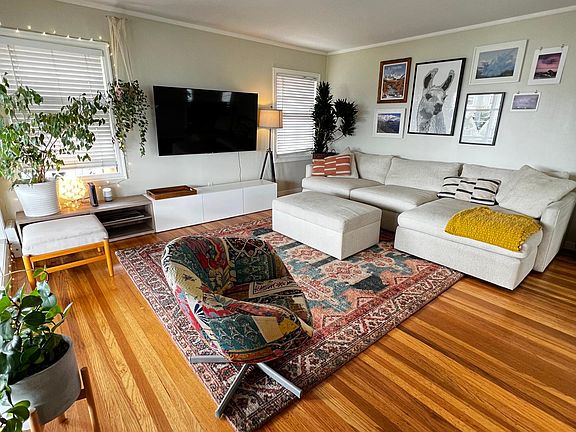 Spacious, light-filled living room. Wall mounted TV is included in rent.