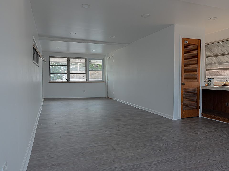Spacious enclosed porch perfect for relaxing, entertaining or enjoying year-round comfort.