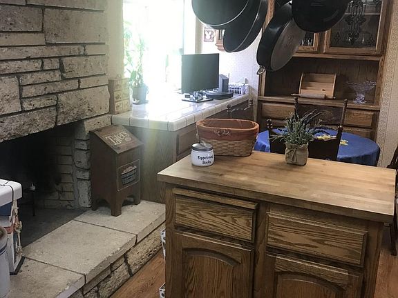 Eat-in kitchen with island and large stone fireplace, furniture NOT included