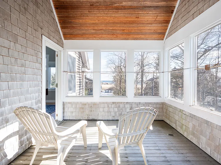 Upstairs outdoor ocean-facing porch with a vaulted bead board ceiling and dry lines for wet towels and bathing suits.