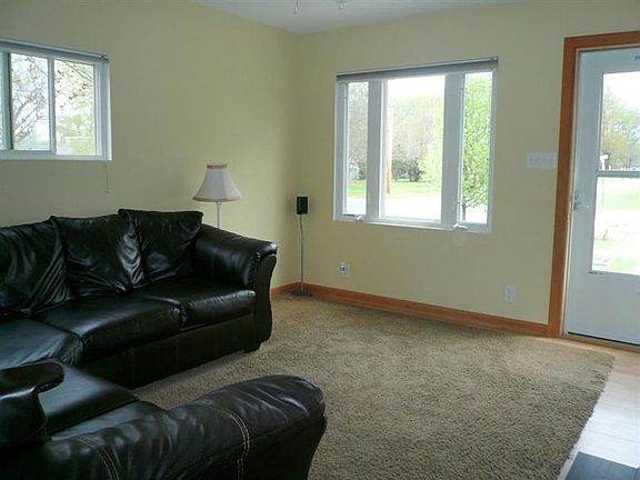 Opposite view of living room and front entry.