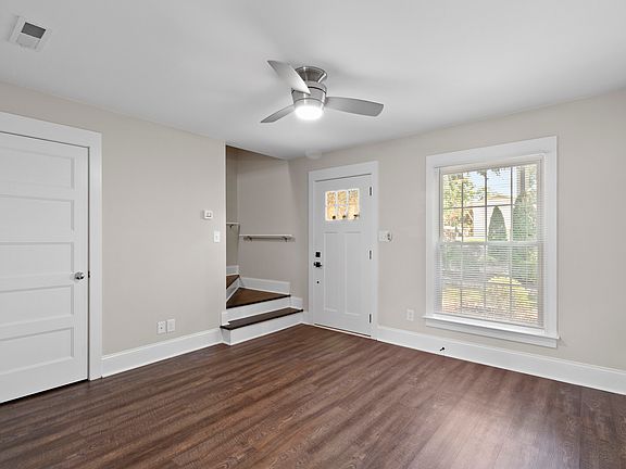 The expansive living room flows to the dining room and kitchen area.