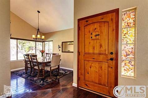 Dining room with high ceilings and wood floors.