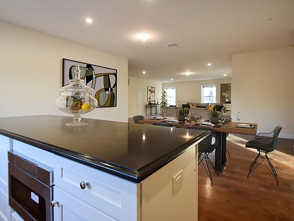 Virtually staged view of kitchen to great room