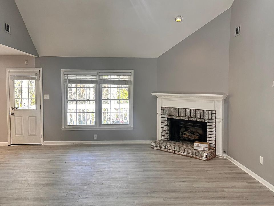 Upstairs living room with brand new floors and a gas fireplace and access to back porch