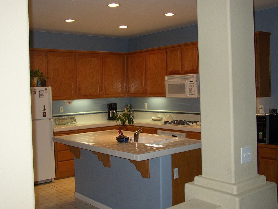 Kitchen w/bar area. Includes area for table as well.