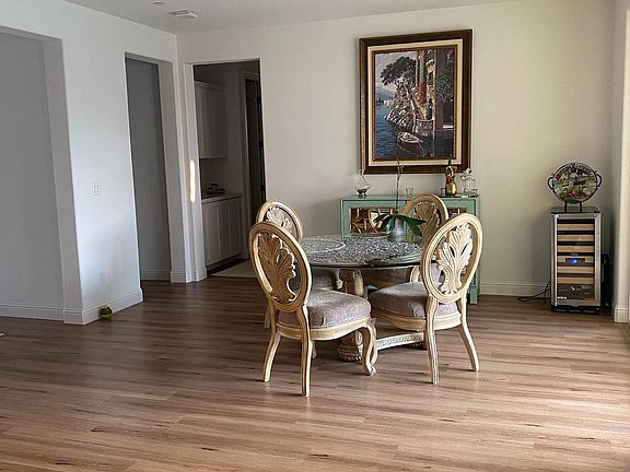 Dining area and hallway to a bathroom, bedroom, and owner's suite.