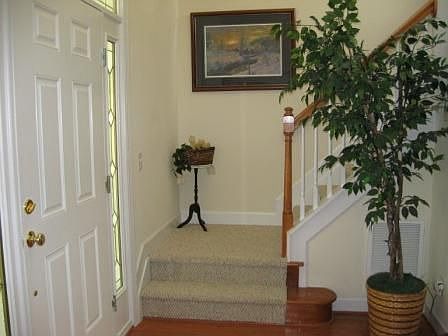 A grand two story foyer greets guests upon arrival. 