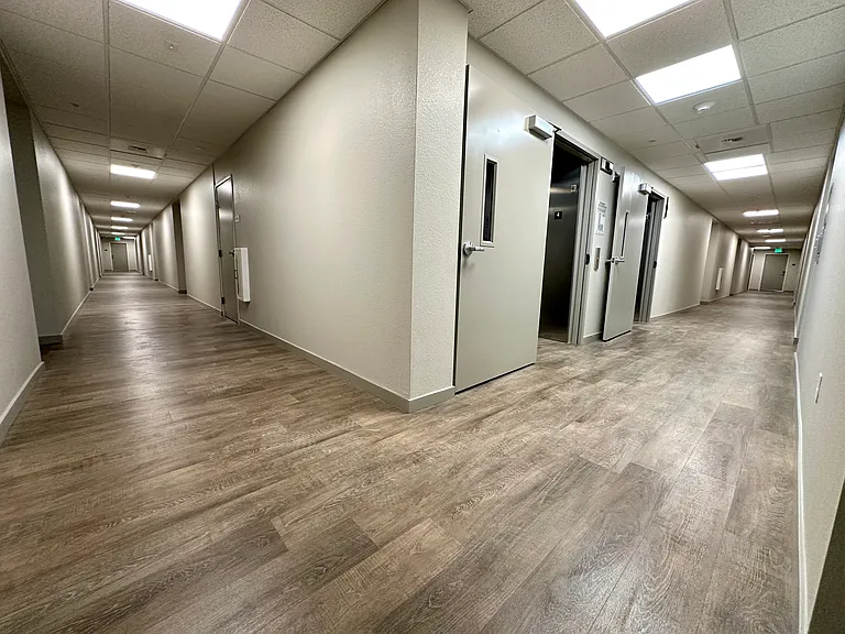 Well-light hallways and two elevators.