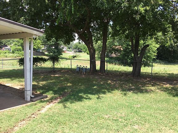 Backyard with covered patio & greenbelt view
