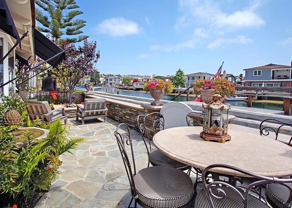Waterfront patio with fountain and fire pit.