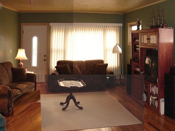Living room enjoys natural light from west-facing windows & hardwood floors.