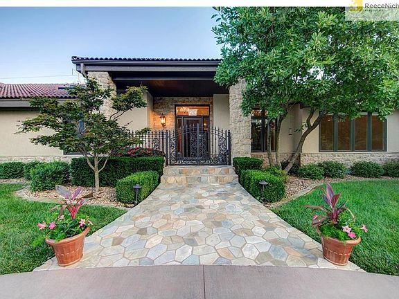 The charming walkway to the wrought iron gate entry is heated to eliminate any ice/snow in the winter months.