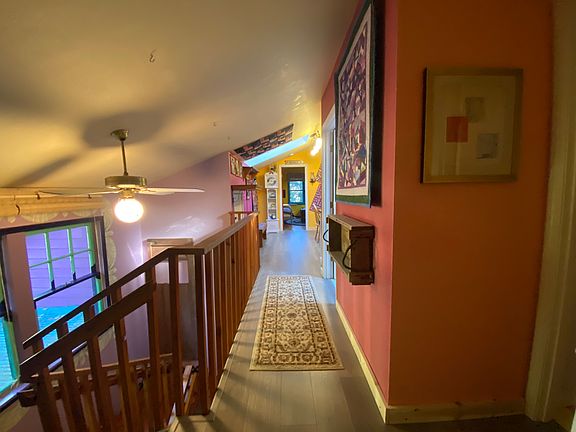 Walkway from primary to secondary bedroom with bathroom and kitchenette in between