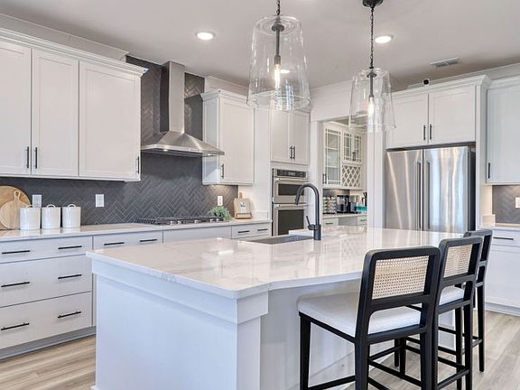 Spacious open-concept kitchen with modern finishes and ample counter space.
