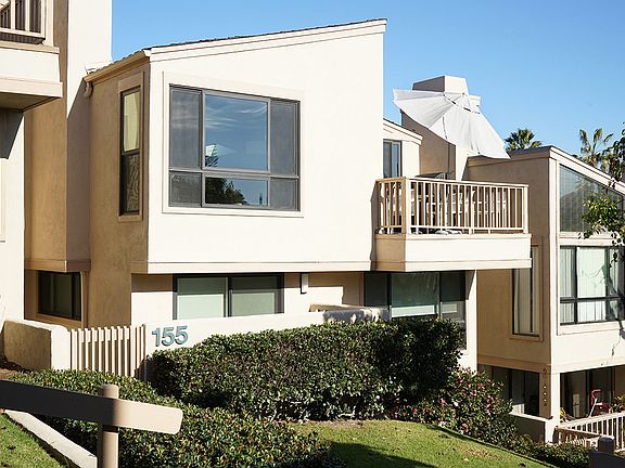 This two story sunny updated condo with balcony and patio