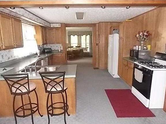 Kitchen. View of 14x15 Kitchen with double stainless steel sink. Convenient breakfast bar. Gas range/oven and dishwasher stay.