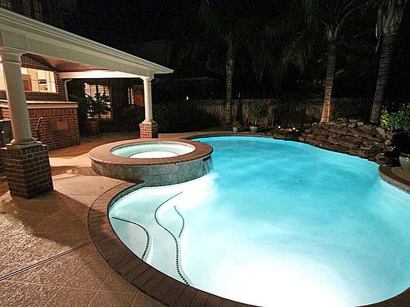 Columns add sophistication to the covered patio and extend the roof partially over the spa.