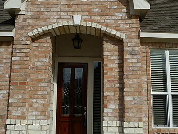 Beautiful stone work on entryway, and leaded glass front door