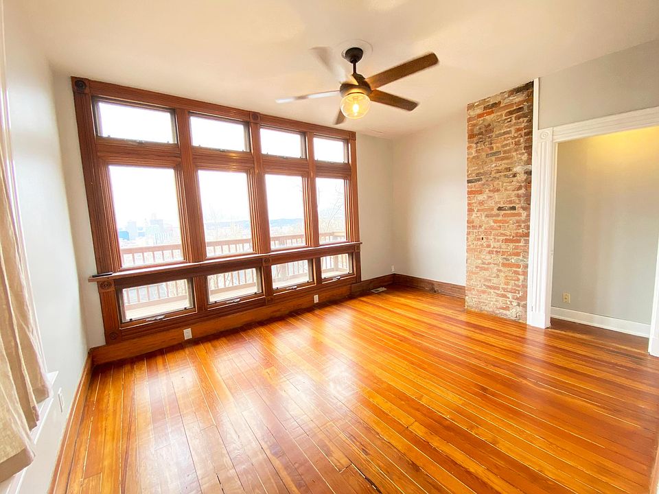 Living room with city views and bar rail at the beautiful floor to ceiling window!
