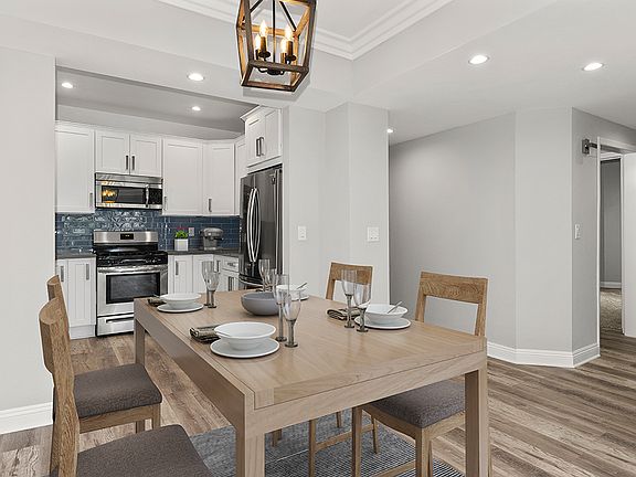 Hardwood floored dining room with view of kitchen.