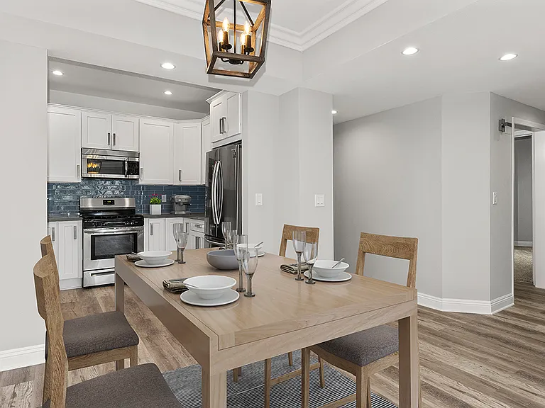 Hardwood floored dining room with view of kitchen.