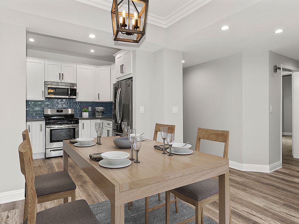 Hardwood floored dining room with view of kitchen.