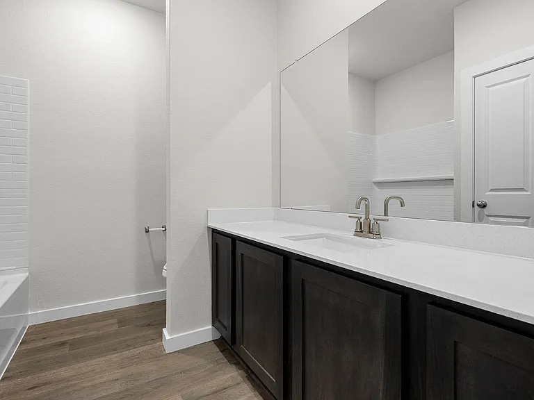 The secondary bathroom has a sprawling vanity space.