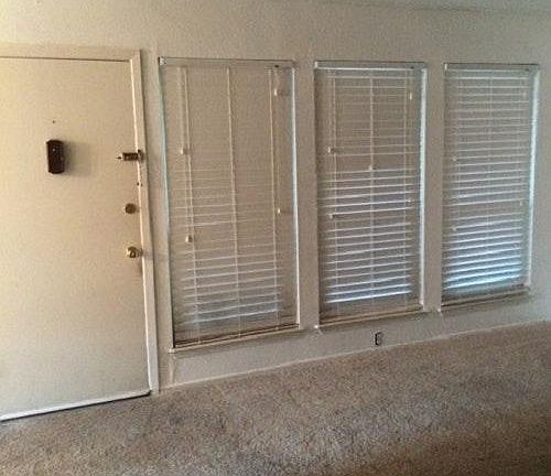 Living room has lots of windows to let in natural light