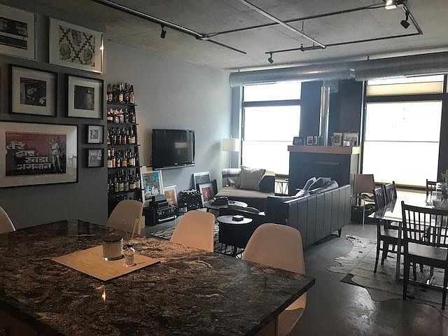 Open floor planwith a gas fireplace and mount for your TV make a great entertaining space.