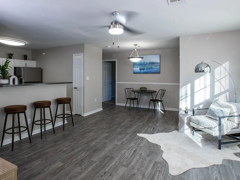 Enjoy the beauty of an uncluttered layout, where sunlight floods through the windows, and a modern, adjustable ceiling fan adds a touch of comfort. Your new apartment sanctuary awaits where open space meets cozy elegance.