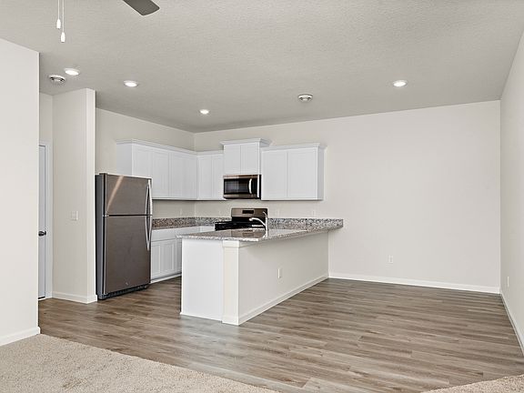 The kitchen is adjacent to the dining room.