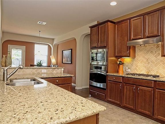 Beautiful Open Kitchen with Granite Counters, Tile Backsplash, and SS Appliances