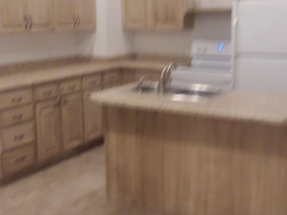 Kitchen with stainless steel sink. 
Island