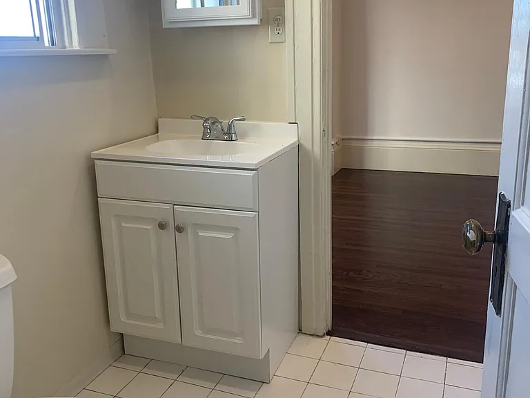 Bathroom cabinet, mirror and new toilet.