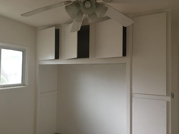 Bedroom two closet with upper cabinets and vertical cabinets