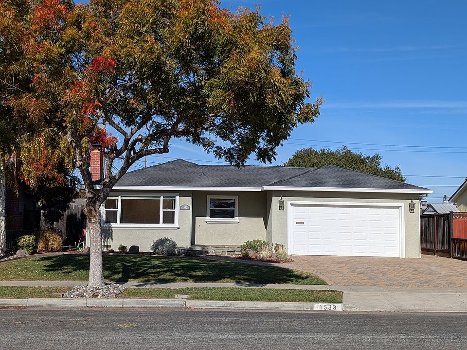 Front yard with spacious lawn and big trees for great shade in the hot months.