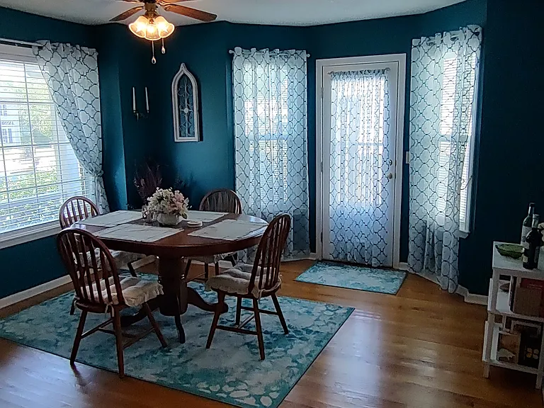 Cheerful dining room w/ oak table and 4 chairs stays as shown, .