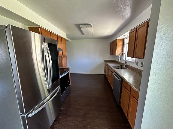 New stainless steel appliances and large farmhouse sink basin