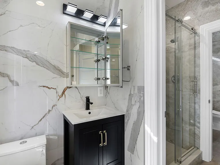 Close-up of rear master bedroom with oversized designer porcelain tile and modern fixtures