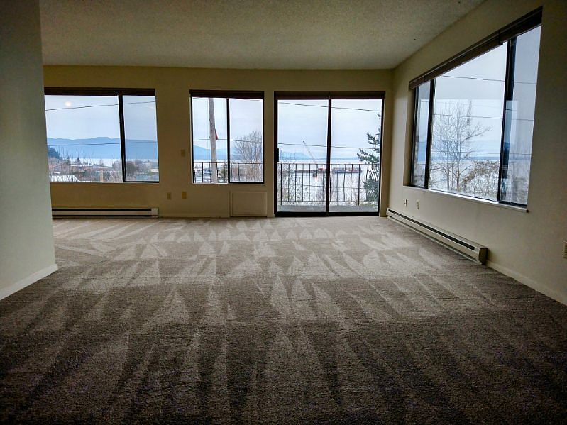 L-shaped living room. View of ferry terminal.