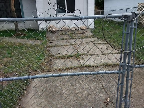 Fenced in driveway secured locked fence