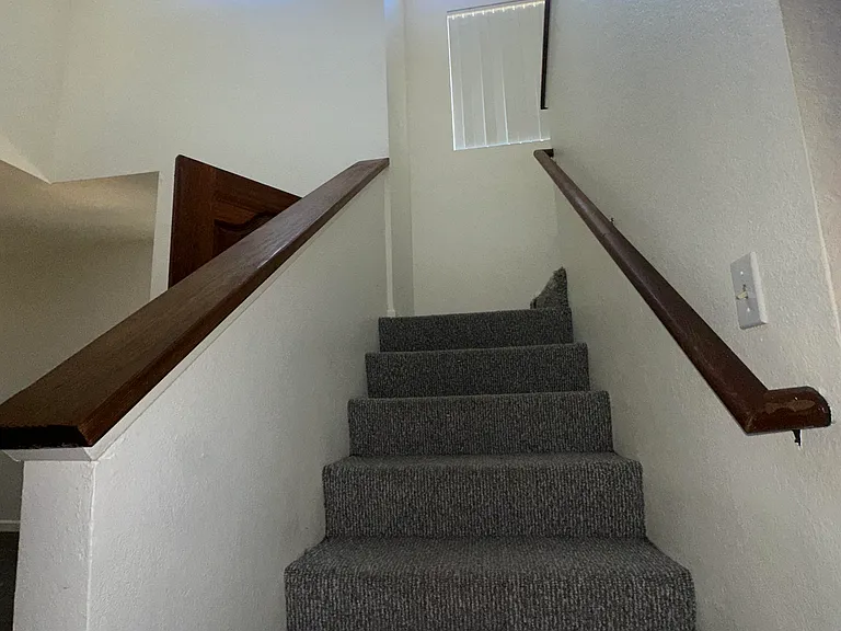 first portion of stairs and windows with lots of natural light
