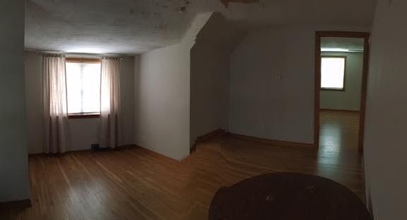 Living room. East facing (house front) double window and ceiling fan.