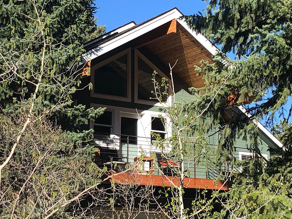 newly built tiny house apartment nestled in the trees view of deck and entrance from the outside